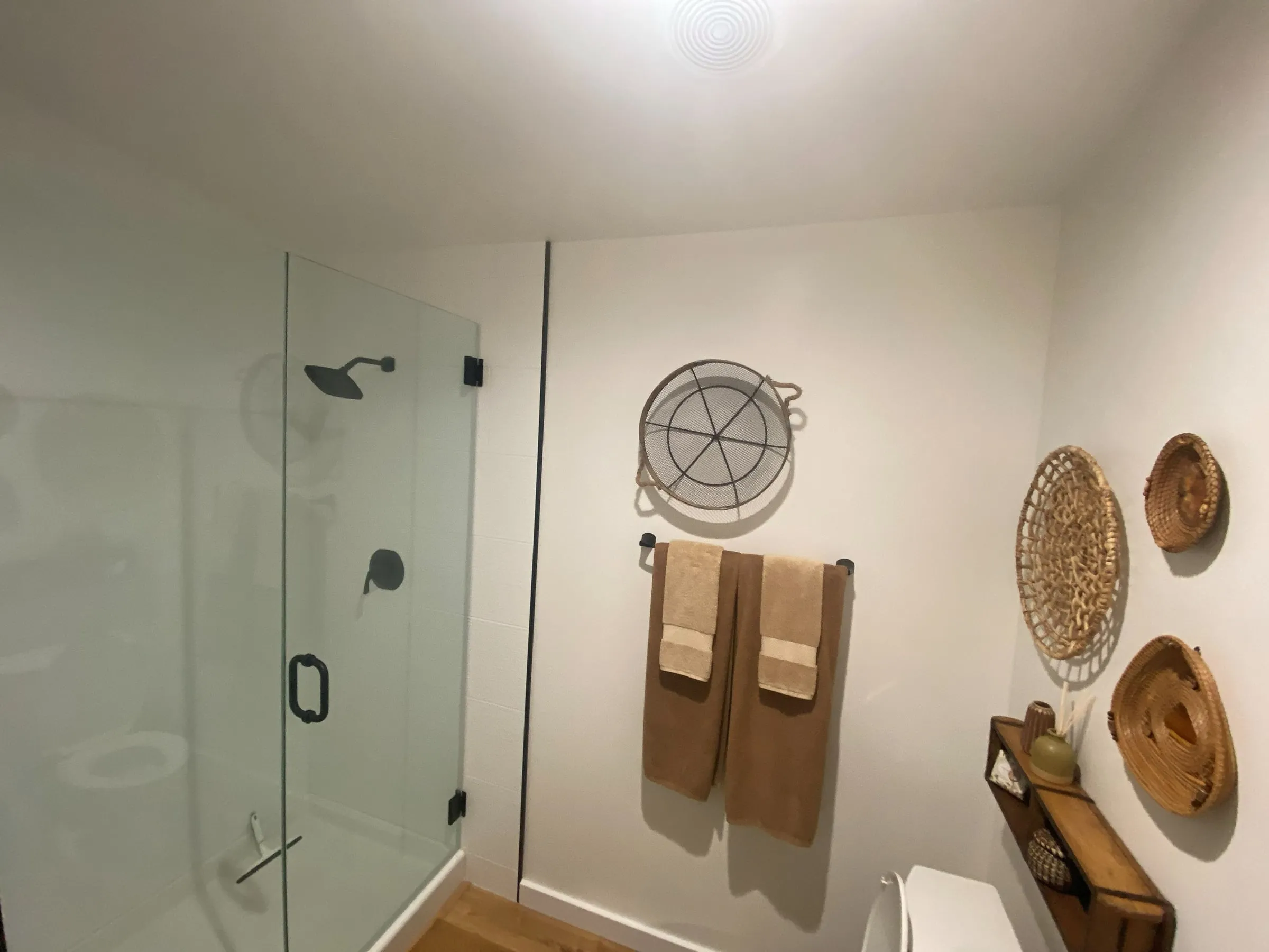 Remodeled bathroom with a frameless glass shower and matte black fixtures