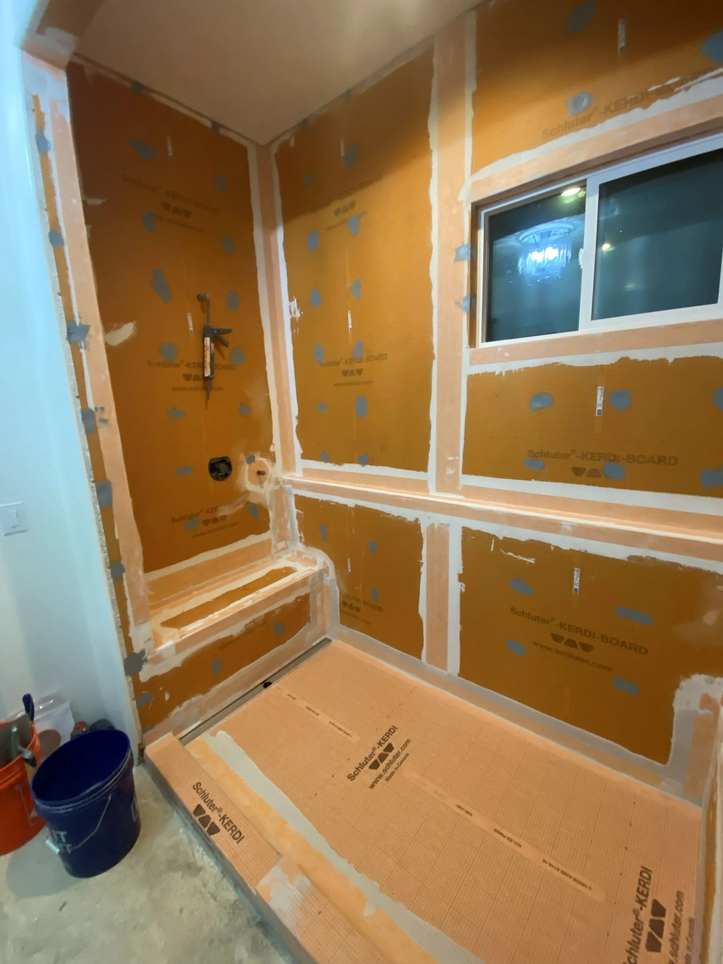 Shower walls and pan waterproofed and ready for tile during a bathroom remodel