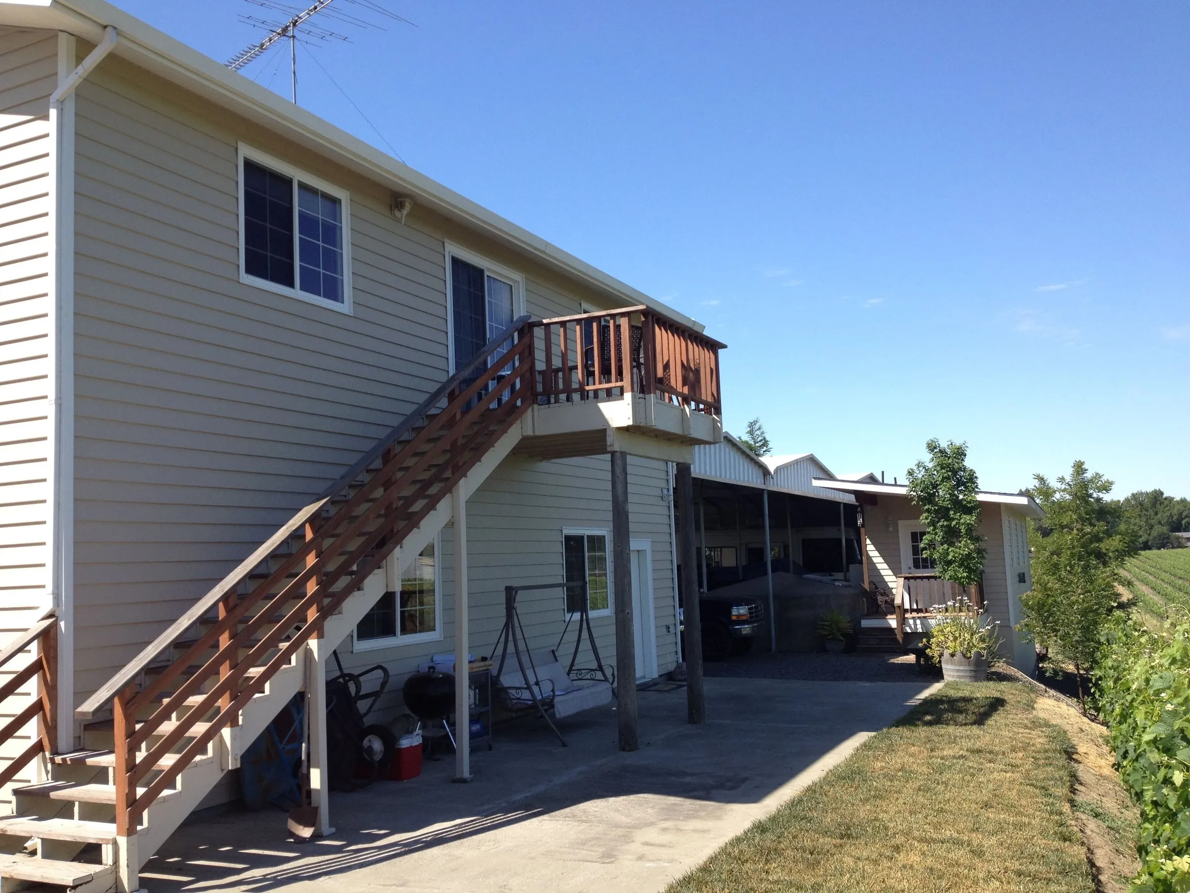 Exterior wood stairs leading up to a second-story deck