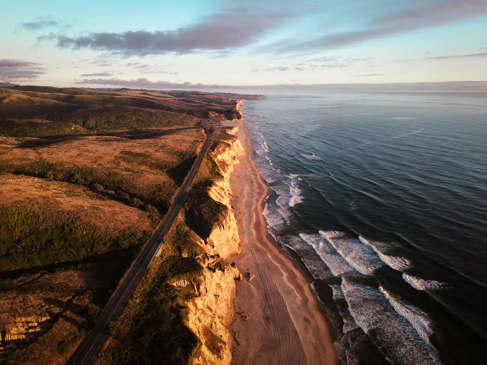 Aerial view of the Half Moon Bay bluffs and beach at sunset