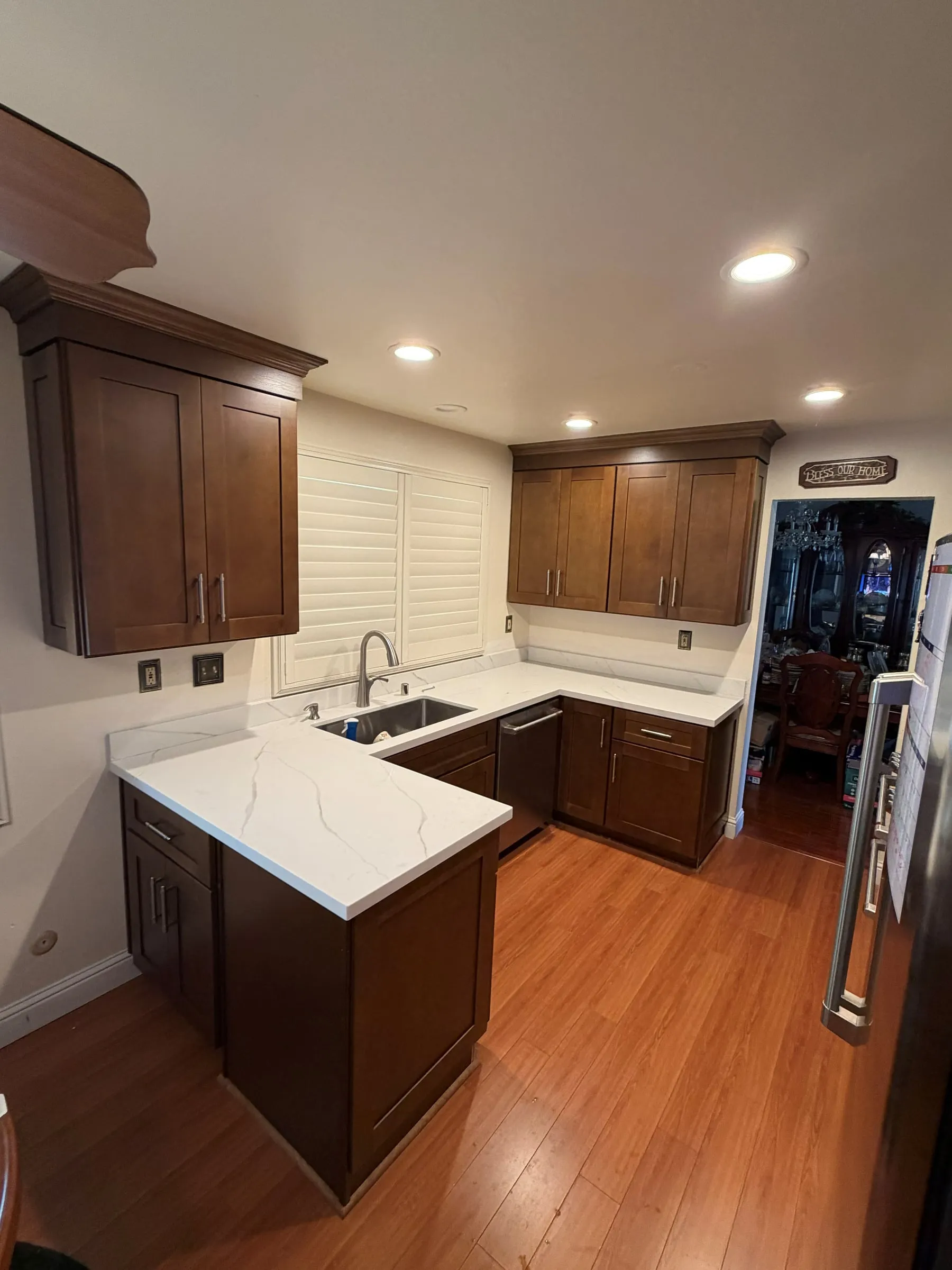 Remodeled kitchen with shaker cabinets, quartz countertops, an undermount sink and recessed lighting