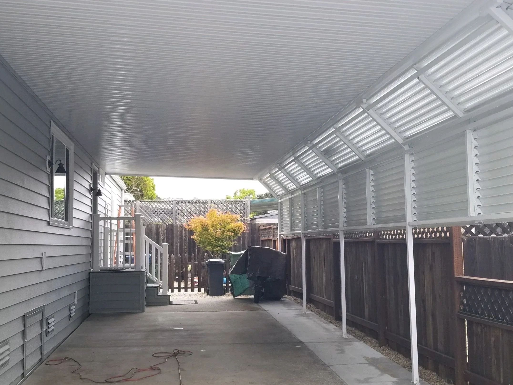 Aluminum carport alongside a mobile home