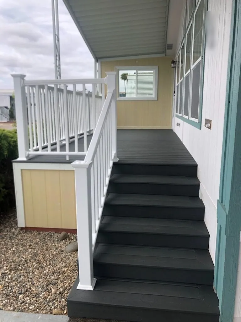 Mobile home entry stairs with composite treads and white railings
