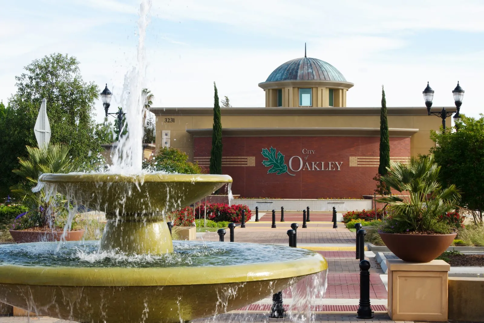 Oakley City Hall with a fountain and palm trees