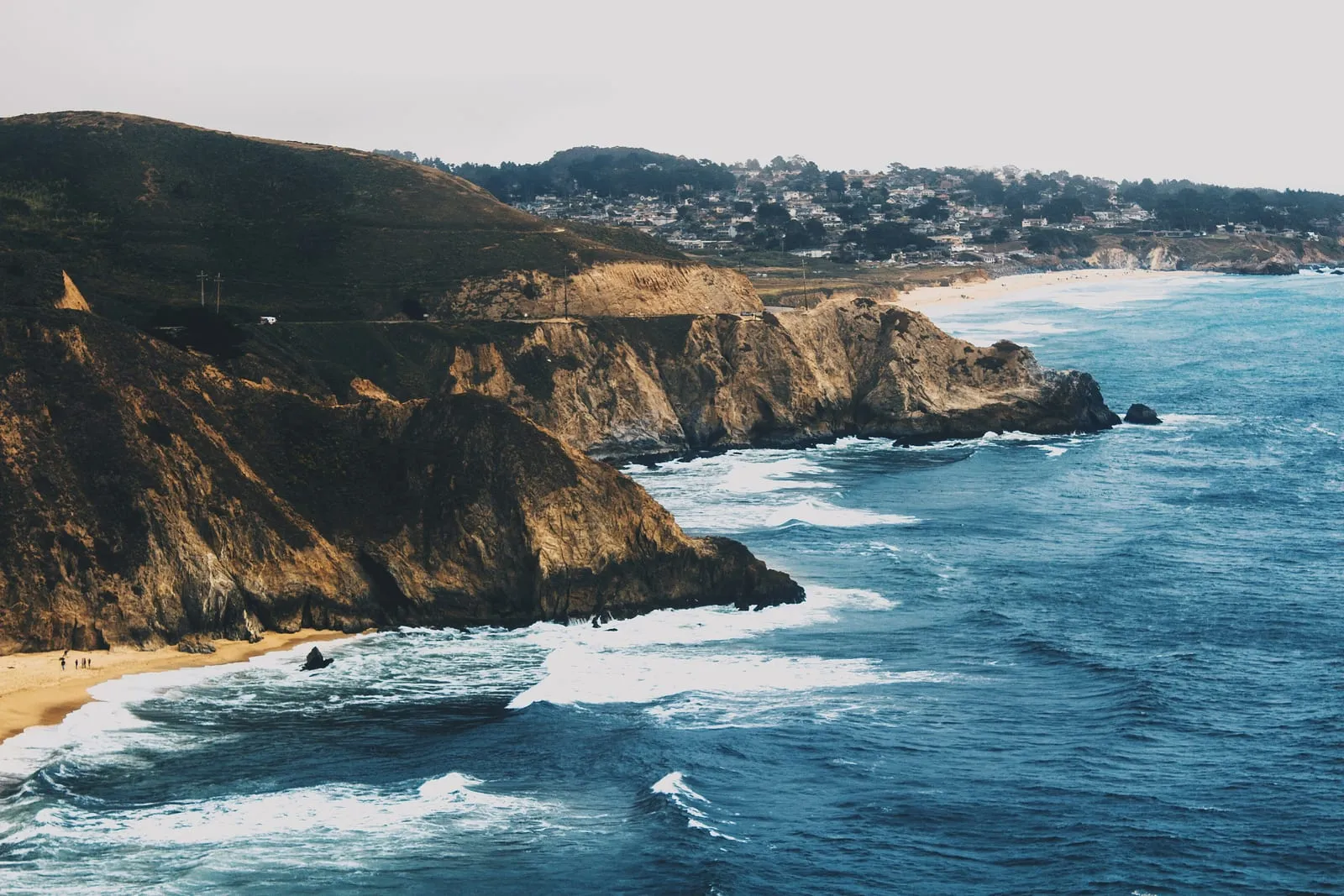 Sea cliffs, surf and hillside homes in Pacifica