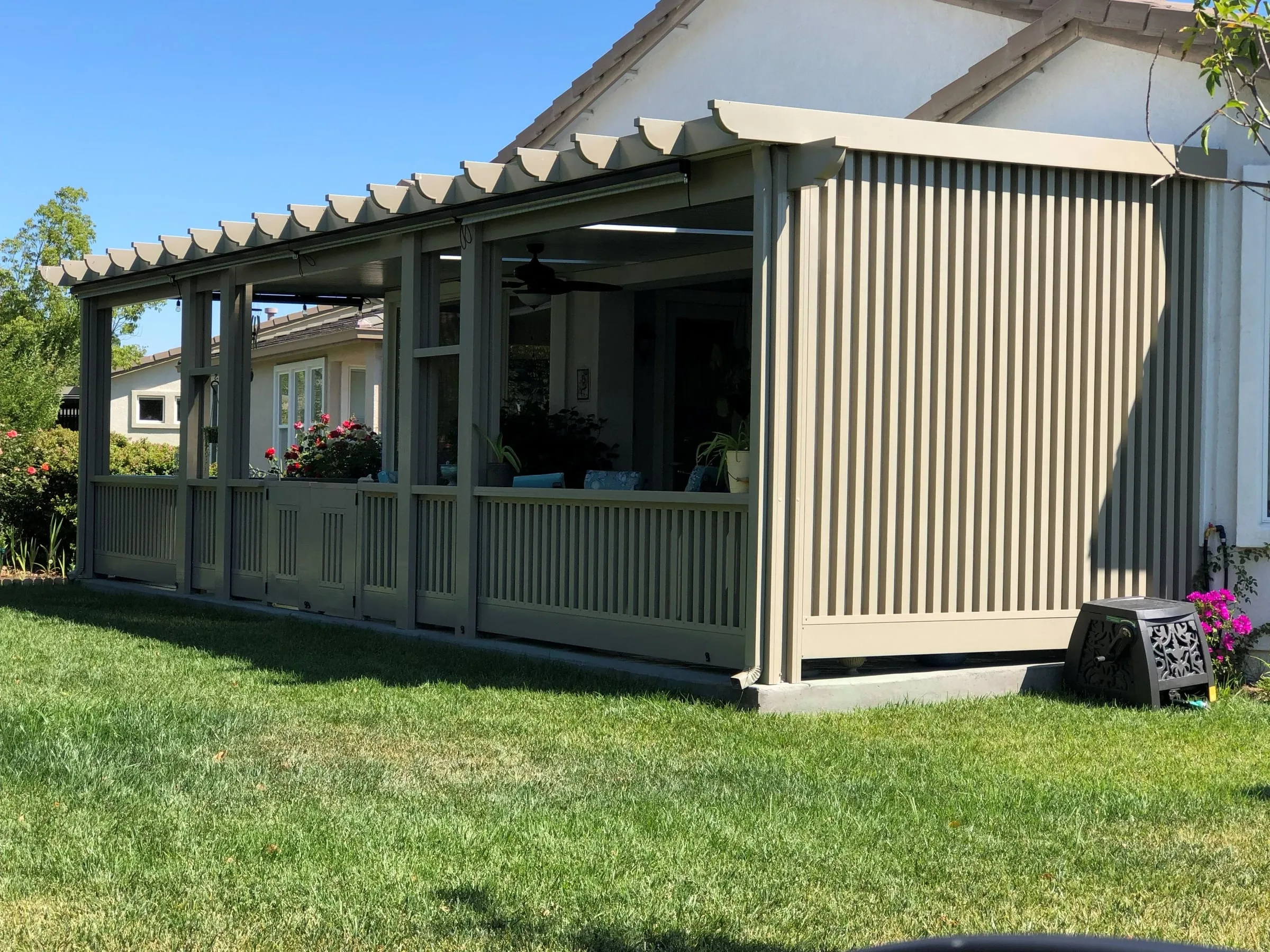 Screen room with solid lower walls under a lattice-edged patio cover