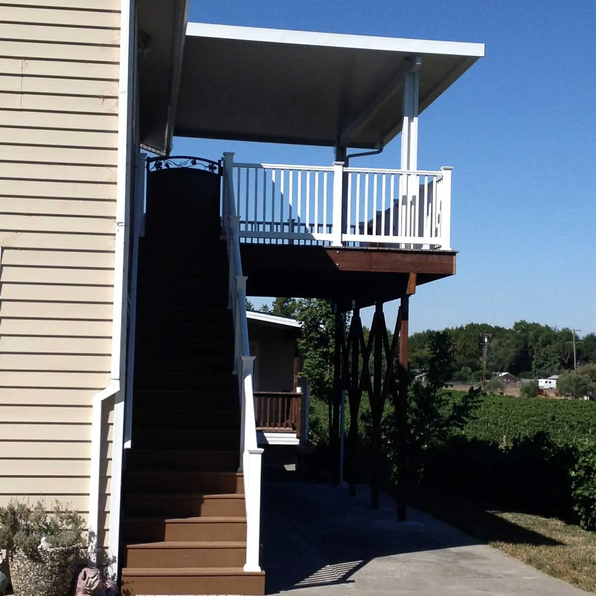 Tall exterior stairs leading to a covered deck