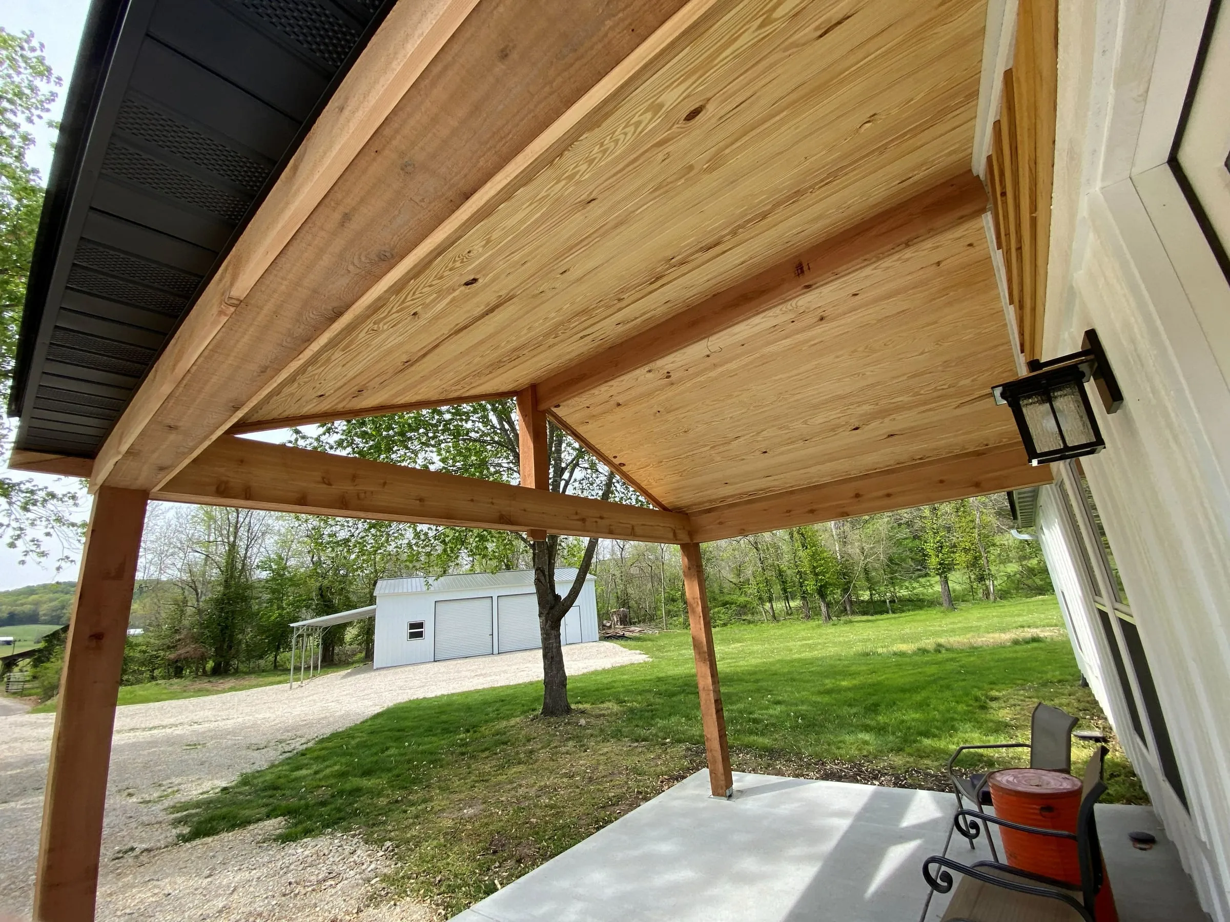 Tongue-and-groove wood ceiling under a gable patio cover